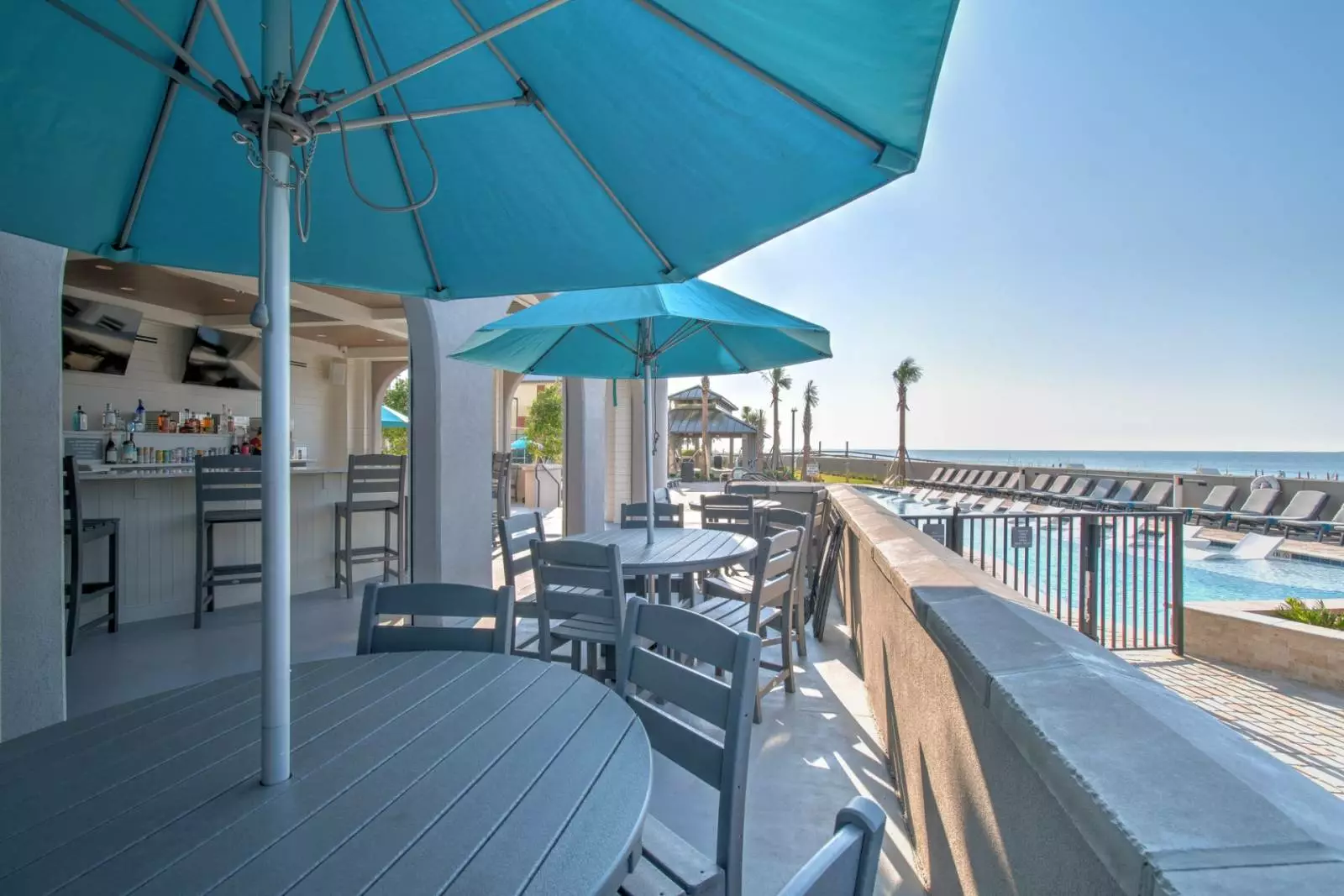outdoor tables overlooking pool and ocean