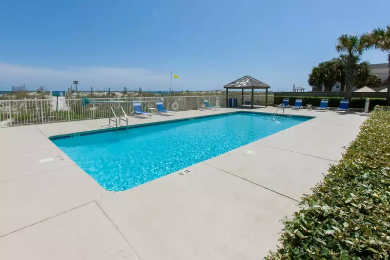 In-ground outdoor pool with loungers at Casa Del Sol.