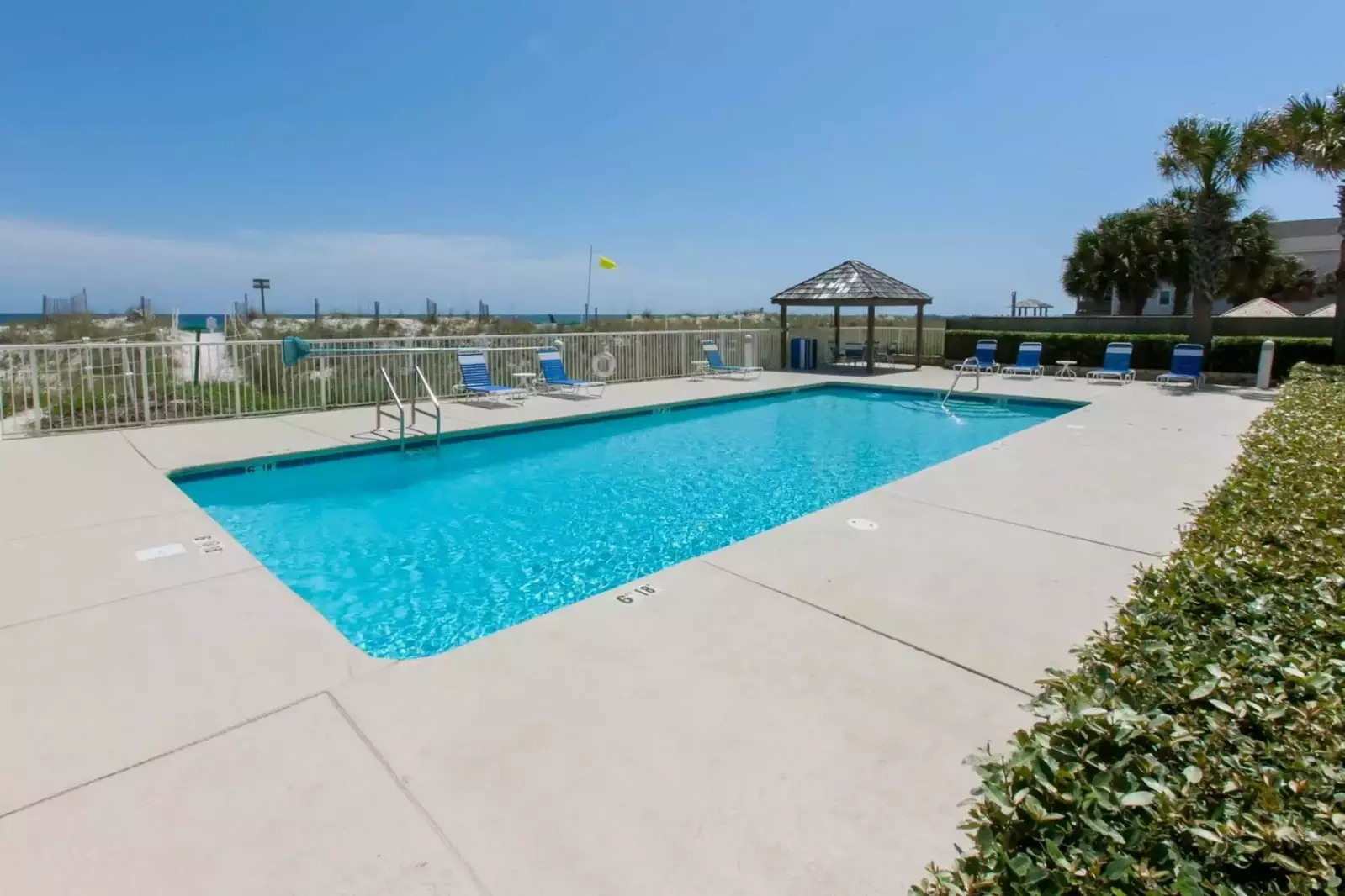 In-ground outdoor pool with loungers at Casa Del Sol.