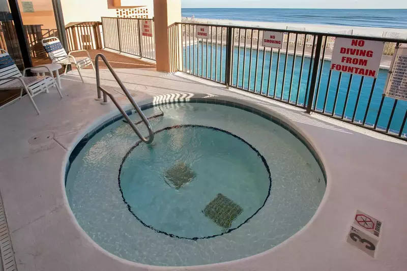 Built-in hot tub with pool, beach and Gulf in background