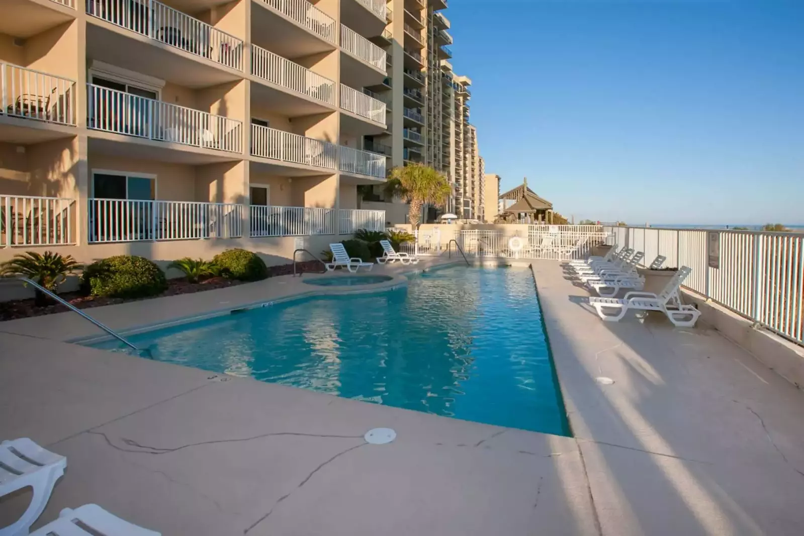 Community pool and hot tub overlooking the beach and the Gulf