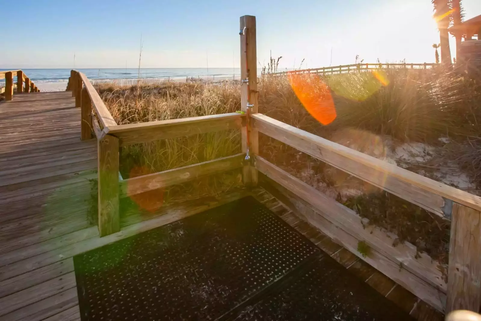 Boardwalk with outdoor shower leading to beach and Gulf