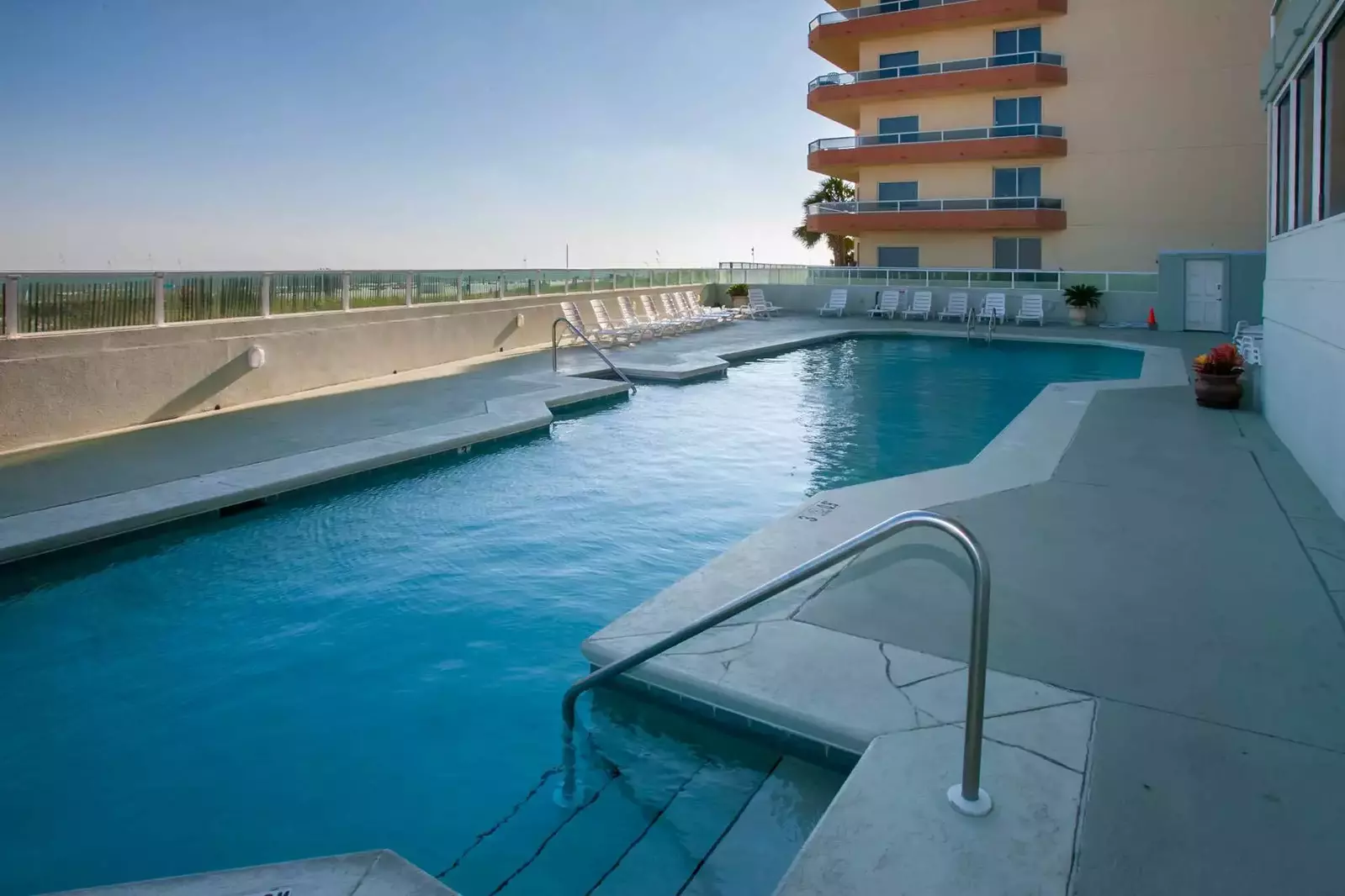 Community pool overlooking beach and Gulf