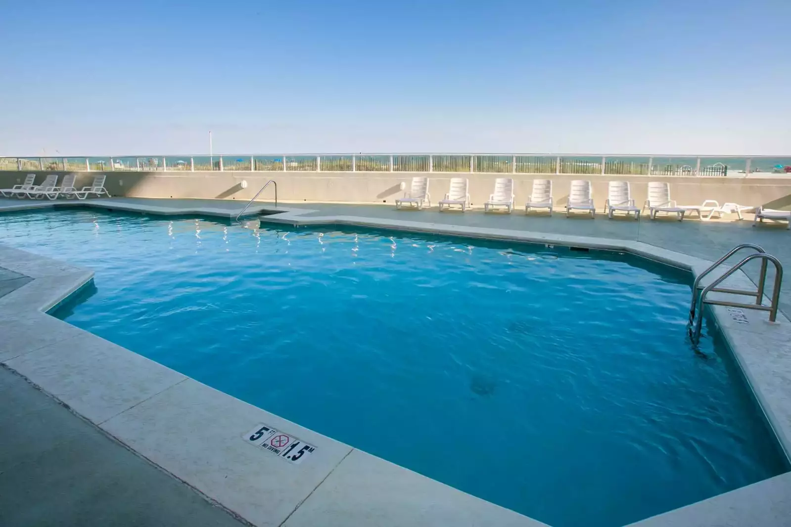 Community pool with beach view
