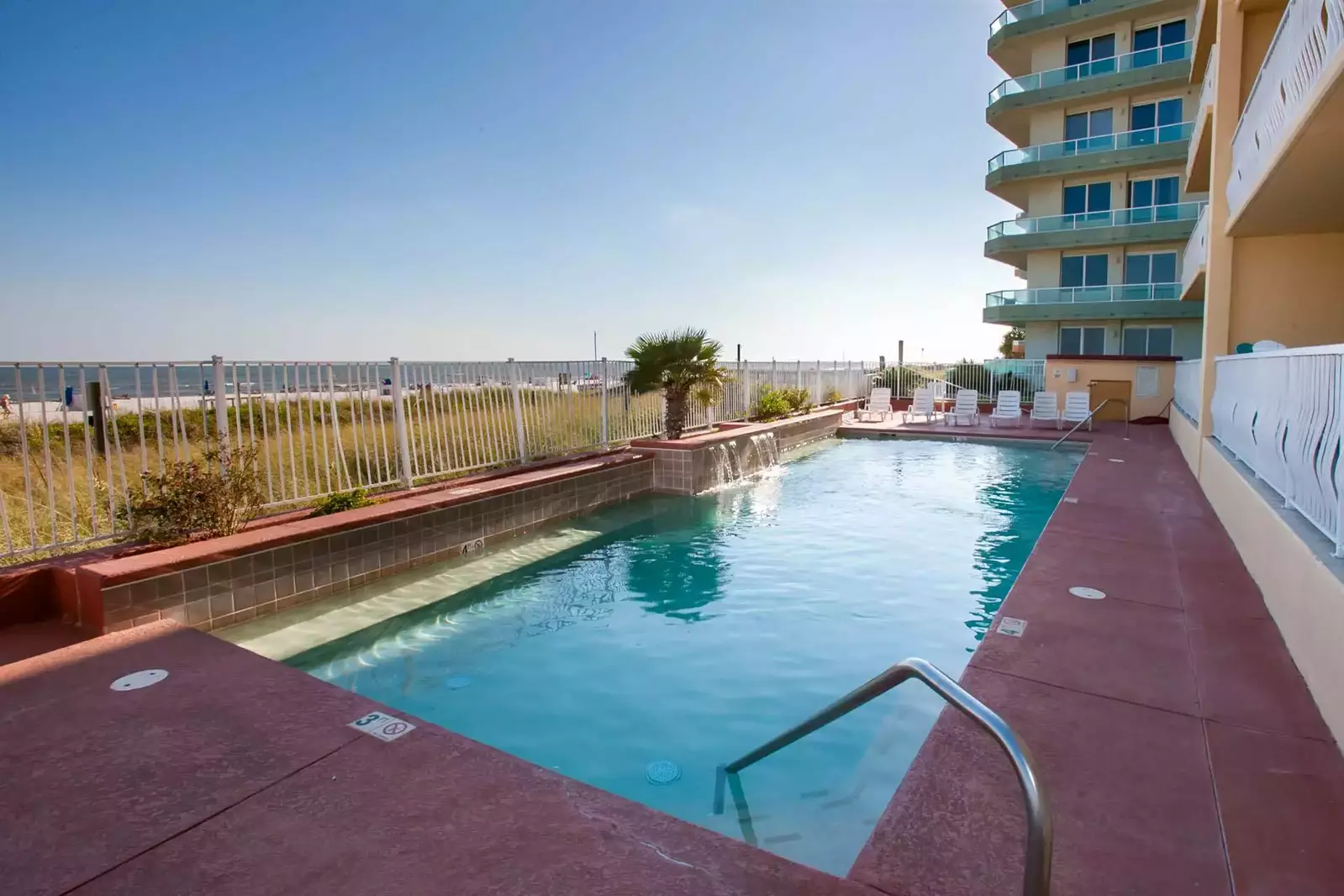 Community pool with waterfall feature