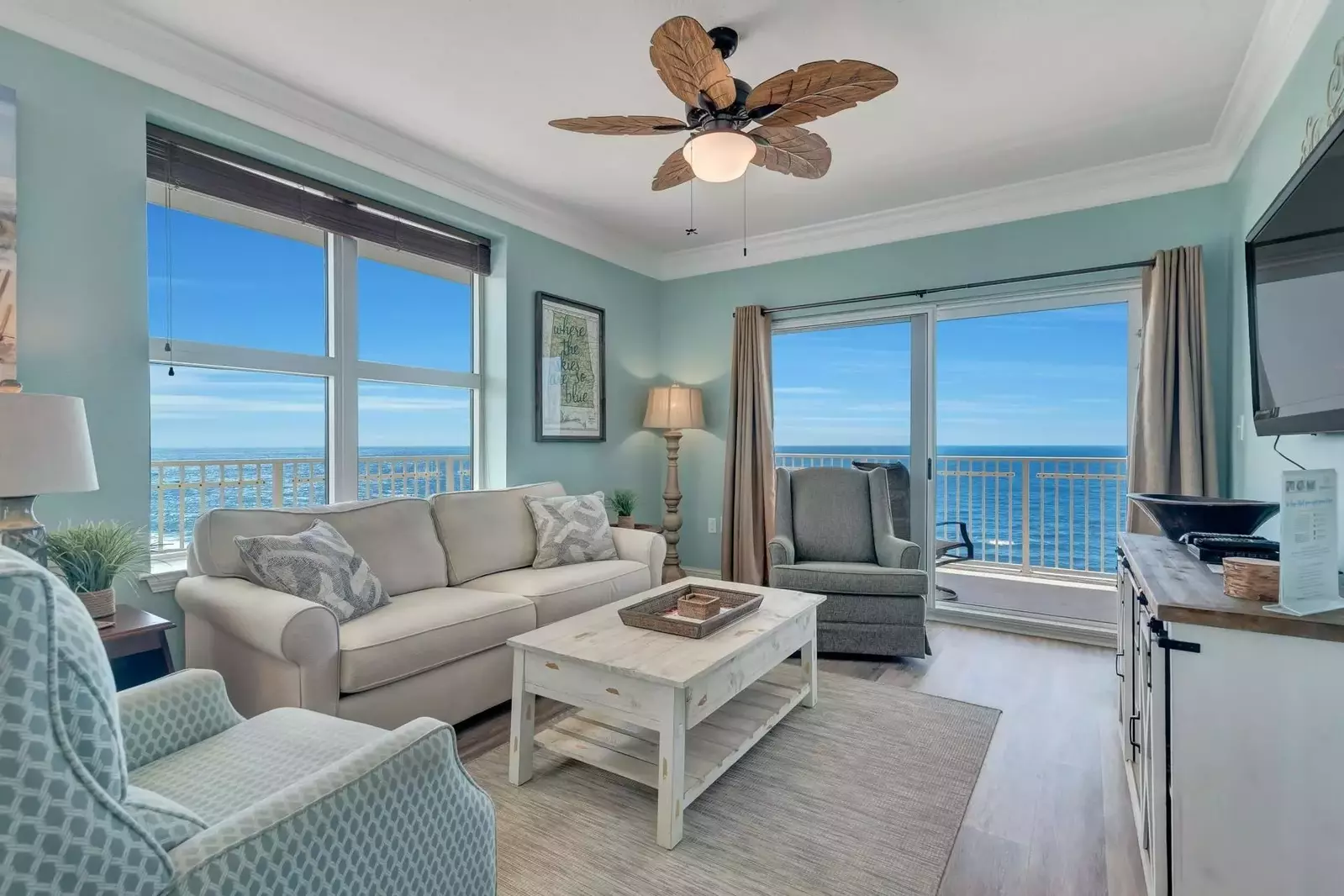 Views of the Gulf from all angles of this tastefully decorated living area with a sofa sleeper and wall mounted TV.