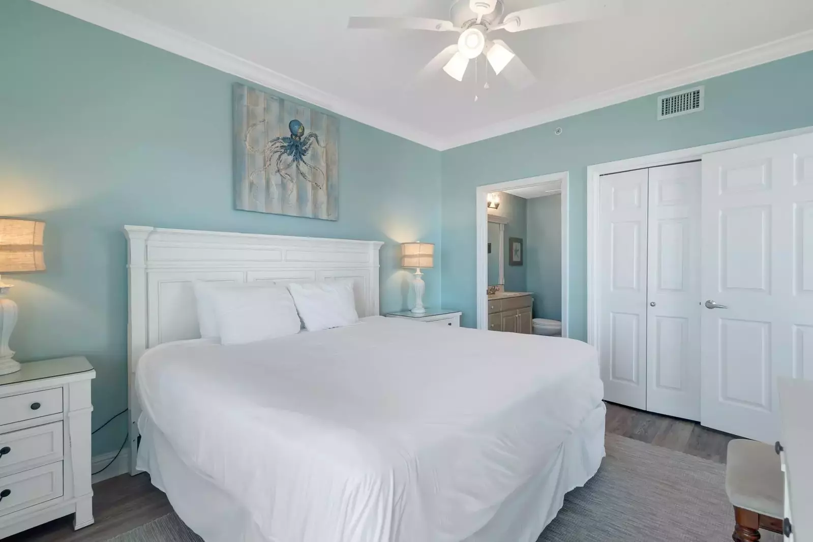 Primary bedroom with king bed, dual nightstands, double closet, and private bath.