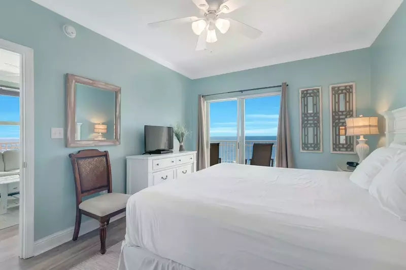Primary bedroom with king bed, flat screen TV with DVD player, and direct Gulf-front balcony access.