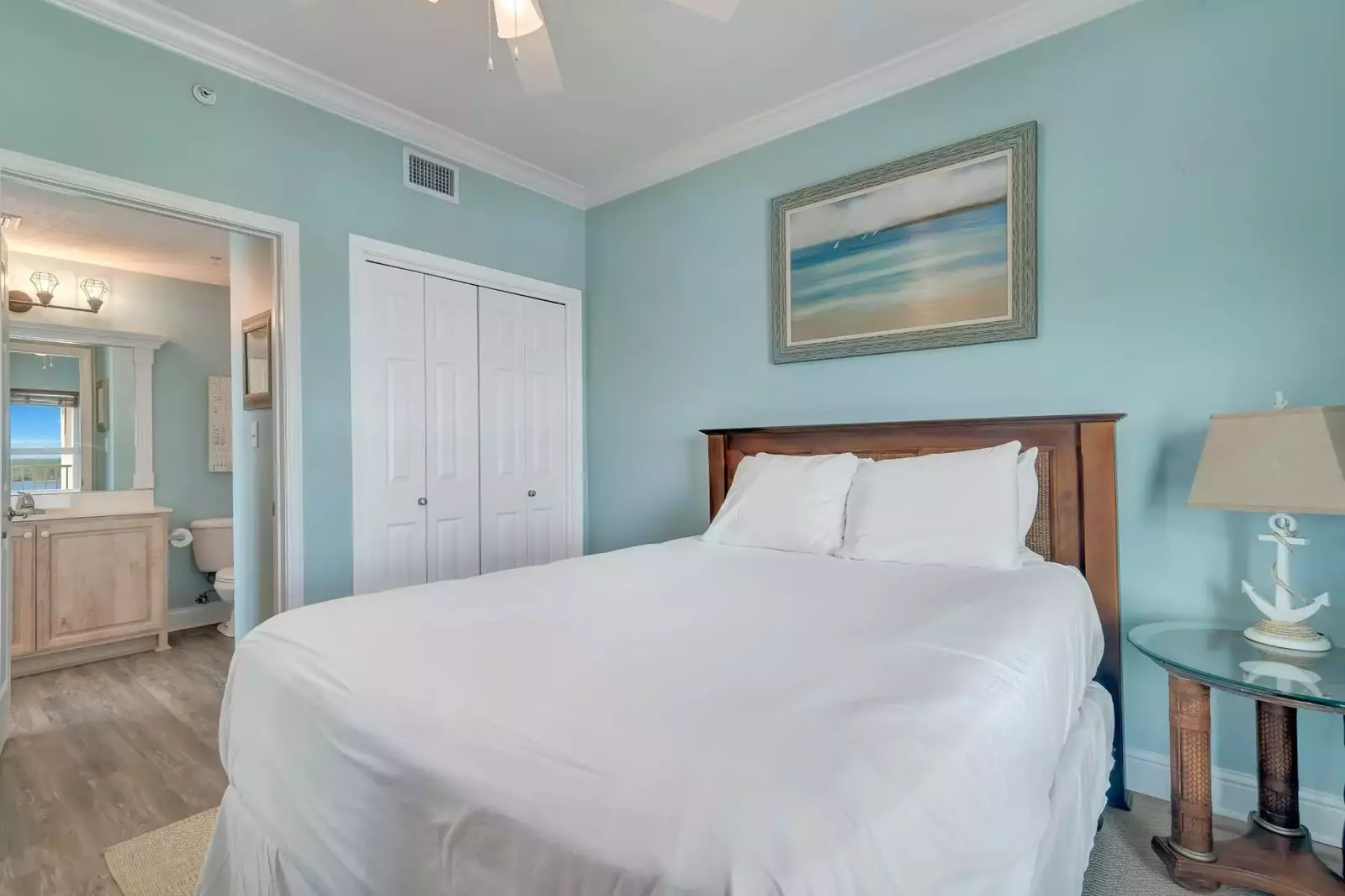 Guest bedroom with queen bed and access to the guest bath. Flat screen TV and ceiling fan, as well.