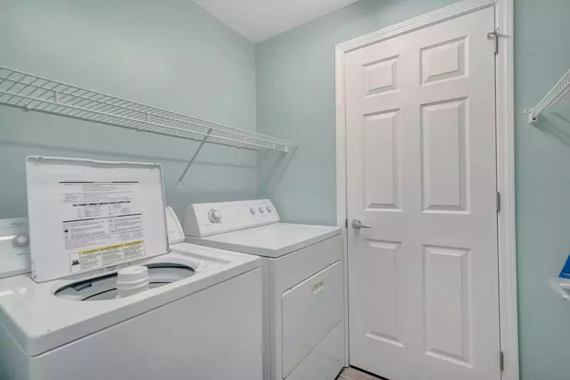 Laundry room with full sized washer and dryer in unit.