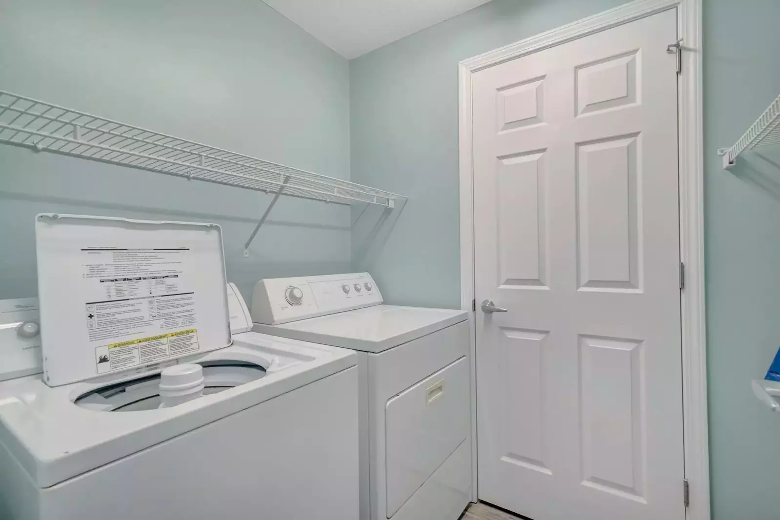 Laundry room with full sized washer and dryer in unit.