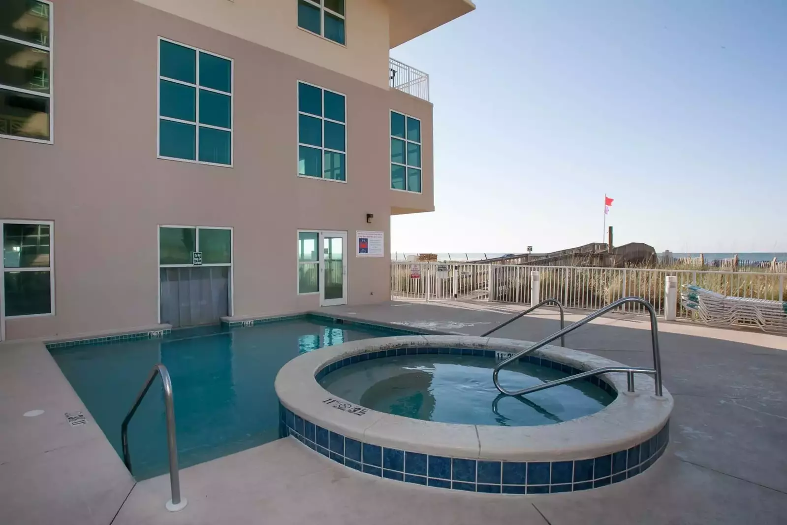 Hot tub overlooking boardwalk to beach.