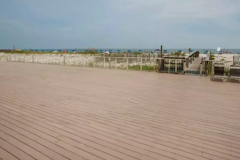 Wide wood deck leading to beach and Gulf