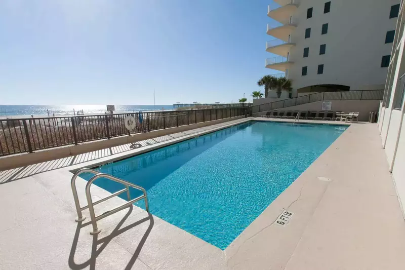 Community pool overlooking the beach/Gulf w/lounge chairs
