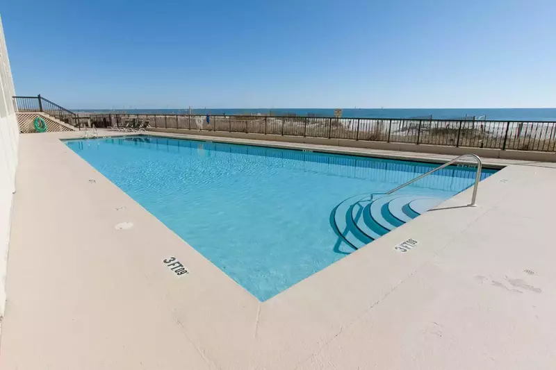 Community pool overlooking the beach/Gulf w/lounge chairs