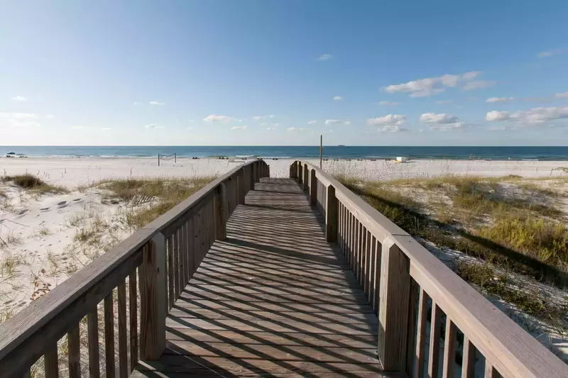 Community boardwalk leading to beach and Gulf