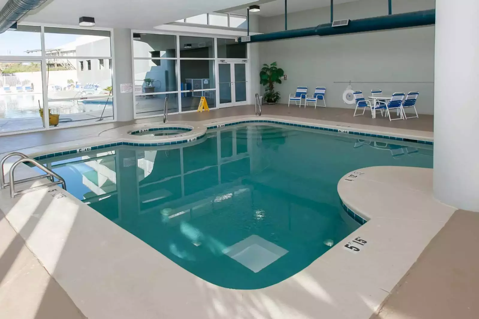Indoor pool overlooking outdoor pool