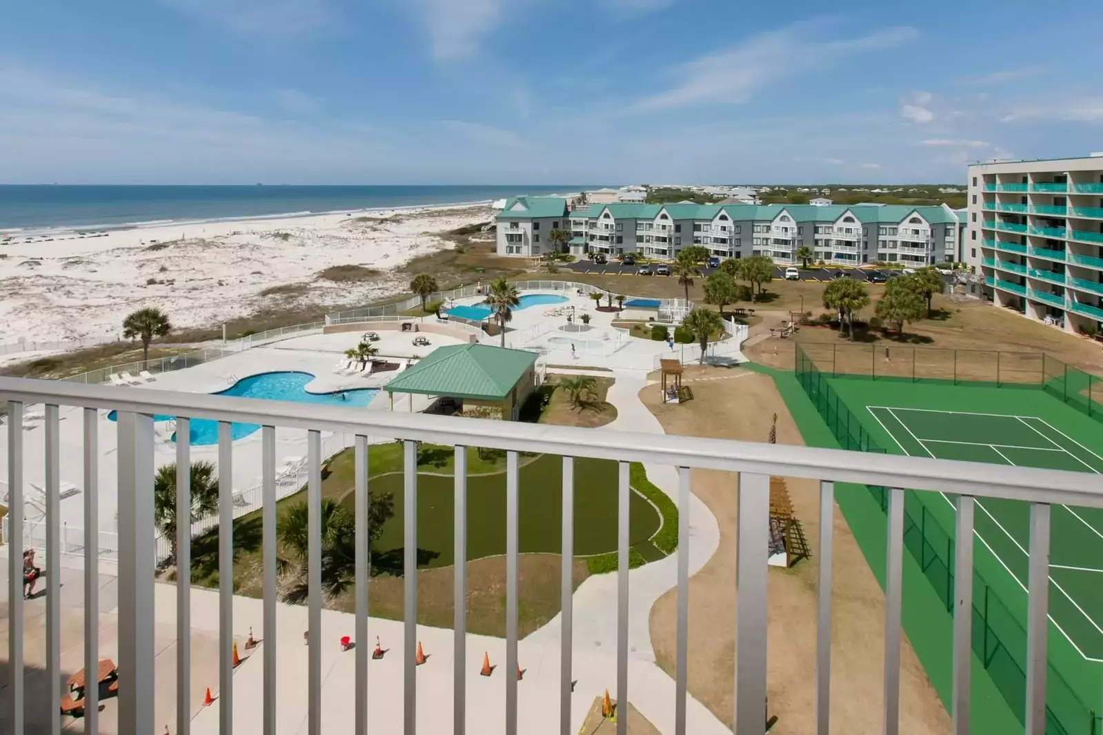 Private balcony with view of tennis court, community pools, beach and Gulf