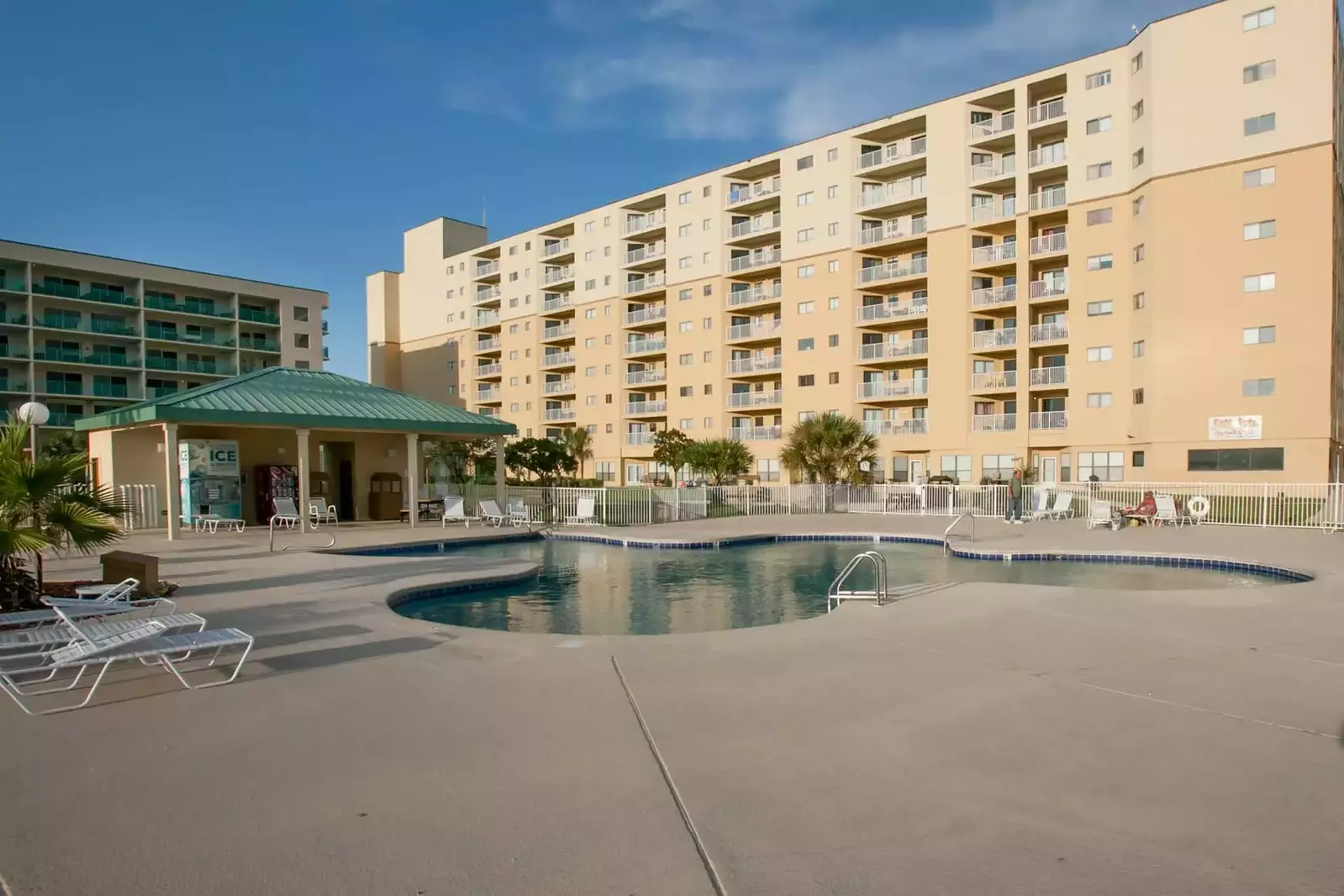 Community pool with lounge chairs and restrooms