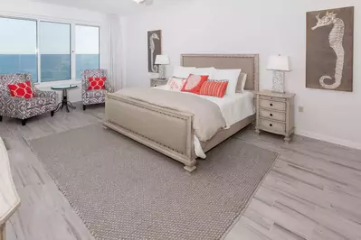 Primary bedroom with king bed, seating for 2 and beautiful Gulf views