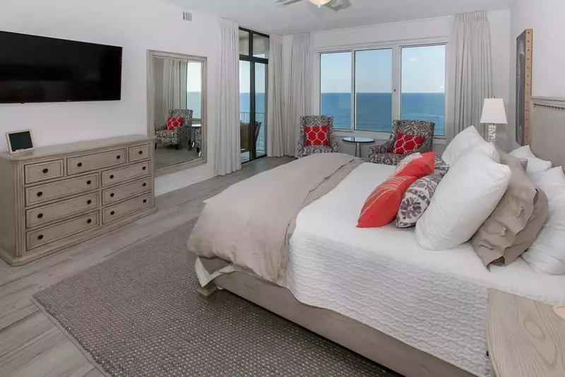 Primary bedroom with double dresser and flat screen TV