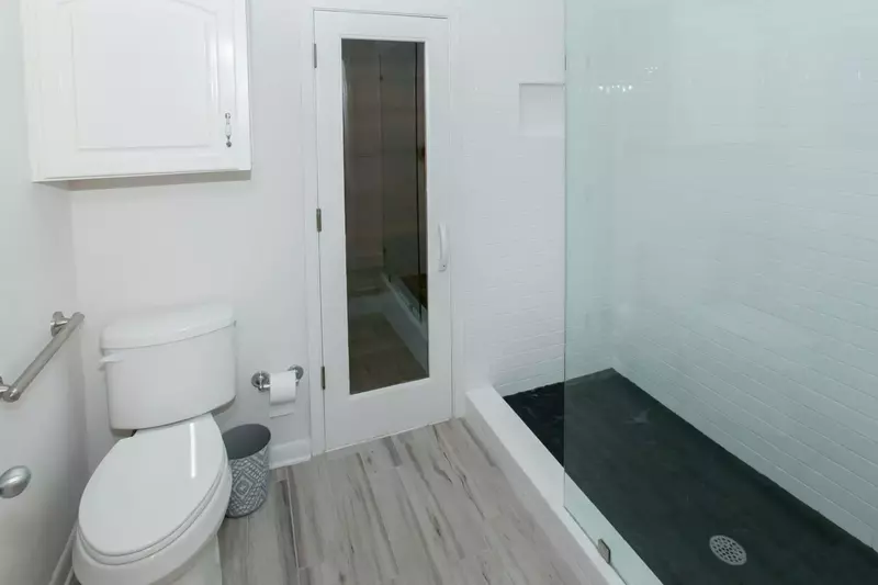 Primary bath with commode and walk in shower