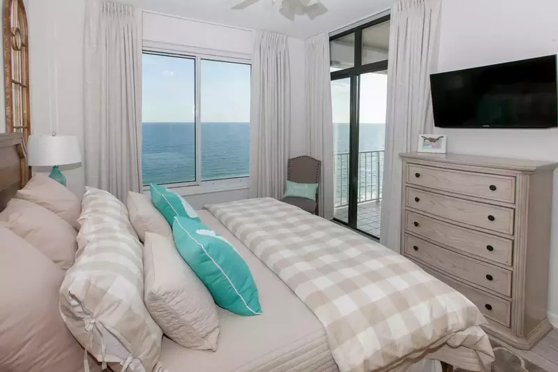 Guest room with Gulf-front balcony access, double dresser and flat screen TV