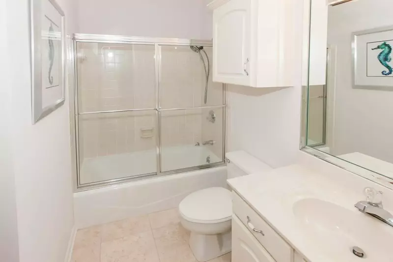 Guest bath with single vanity, tile floors and tub/shower