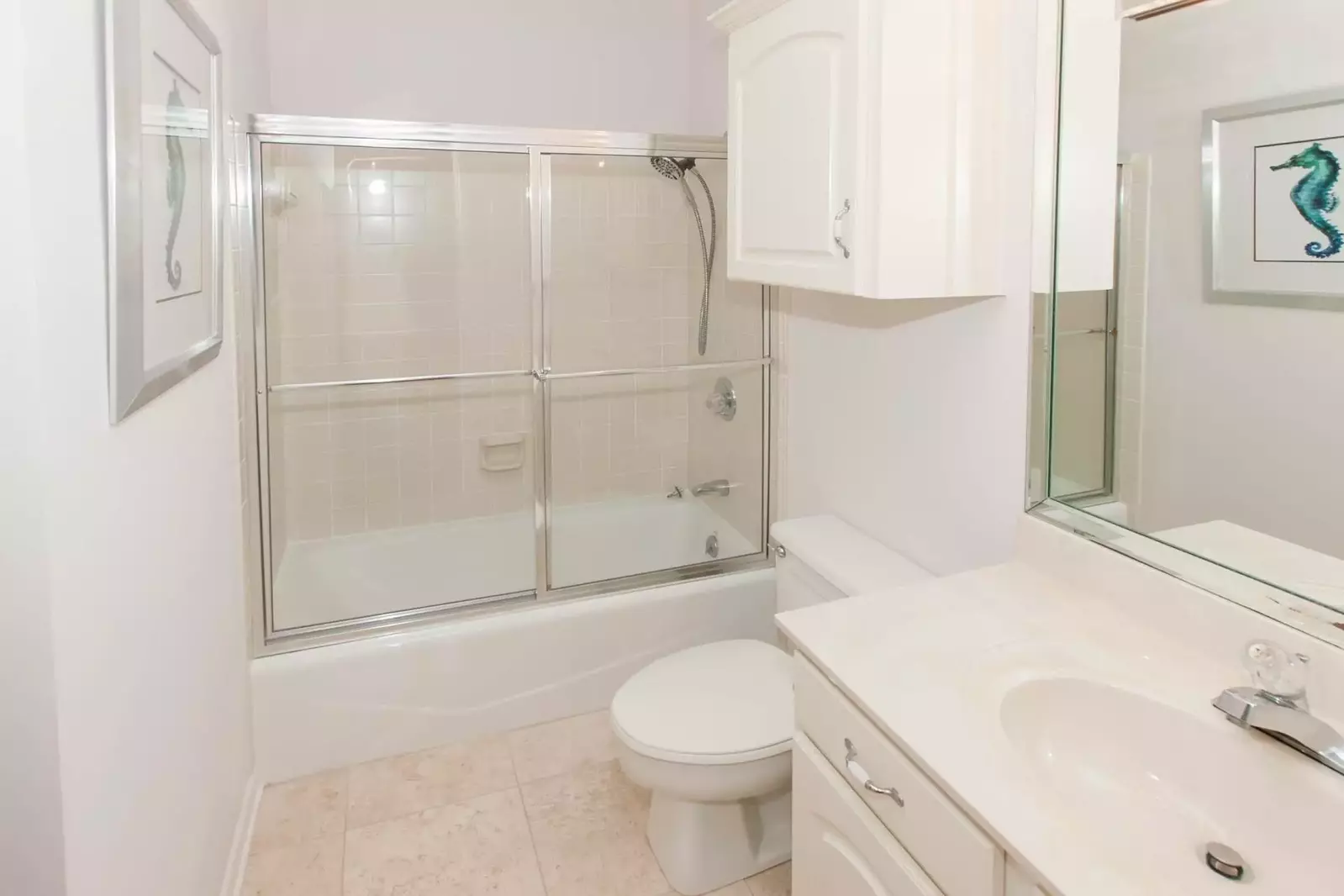 Guest bath with single vanity, tile floors and tub/shower