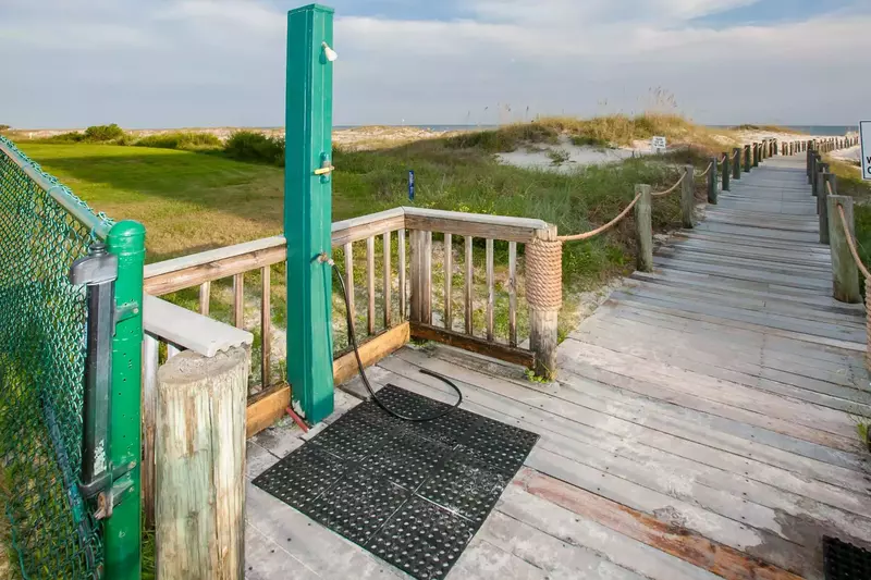 Boardwalk with outdoor shower leading to beach and Gulf