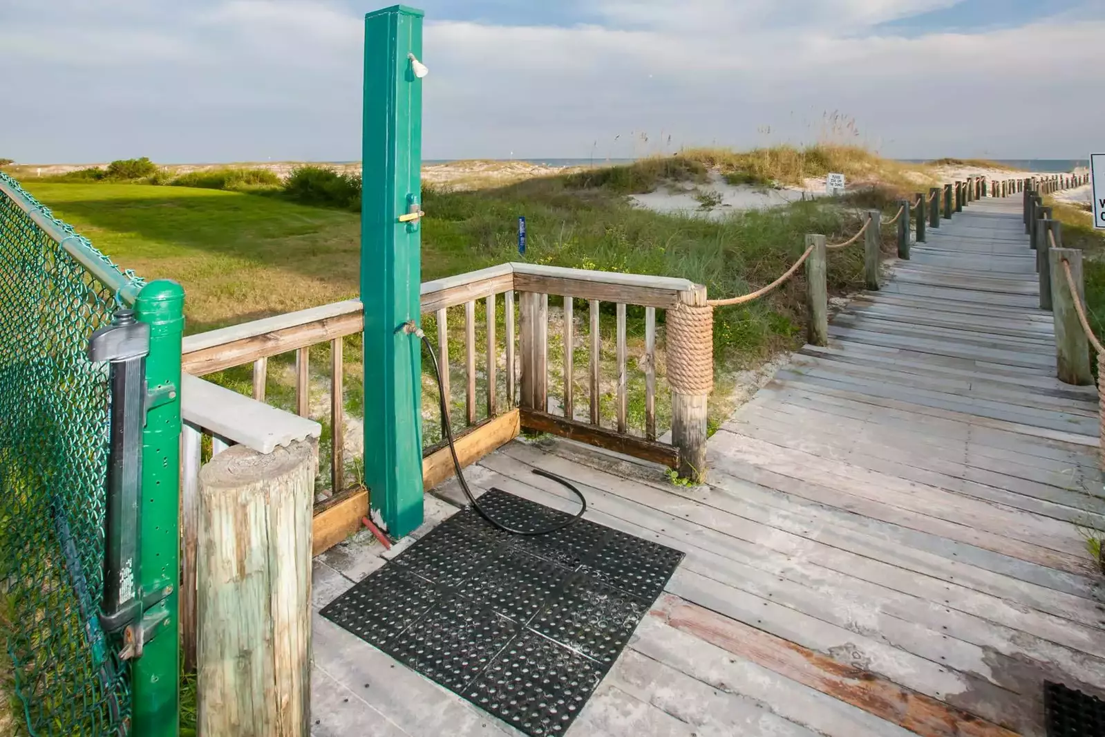 Boardwalk with outdoor shower leading to beach and Gulf