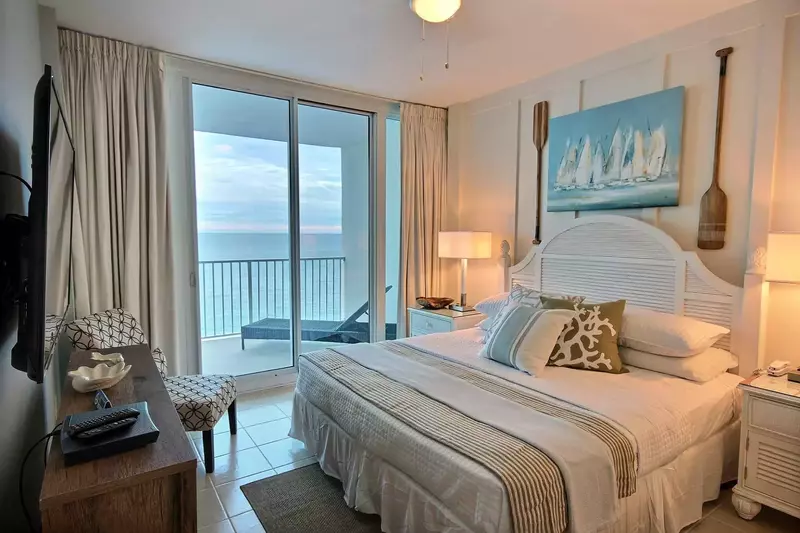 Primary bedroom with king bed and coastal decor
