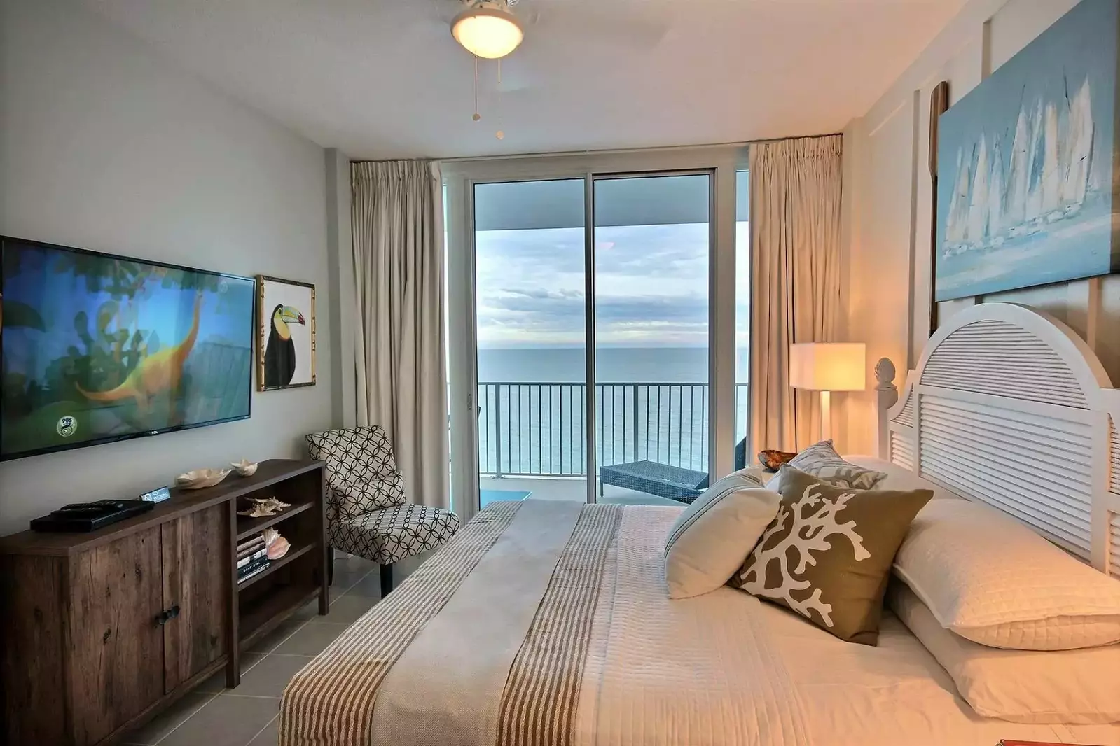 Primary bedroom with 55-inch flat screen TV/DVD and private access to Gulf-front balcony