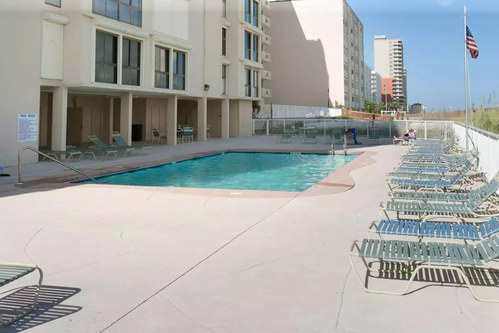 Community pool with covered and open area lounge chairs