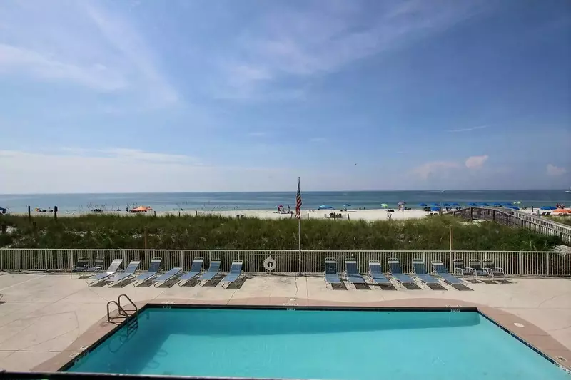 Community pool with plenty of lounge chairs.