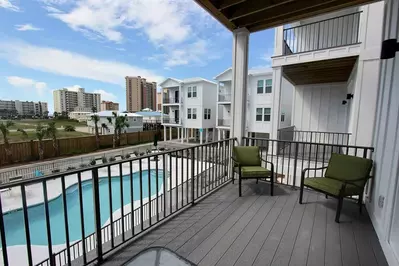 Views of pool and tropical foliage from balcony