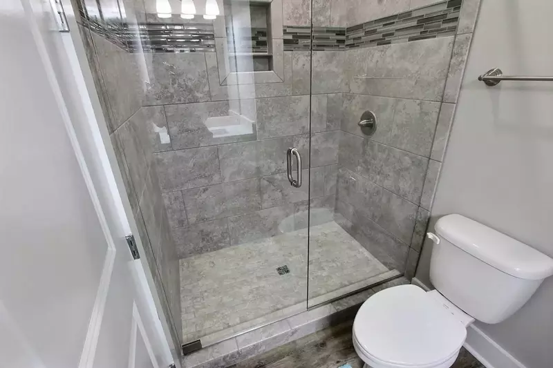 Large tiled walk-in shower in primary bath