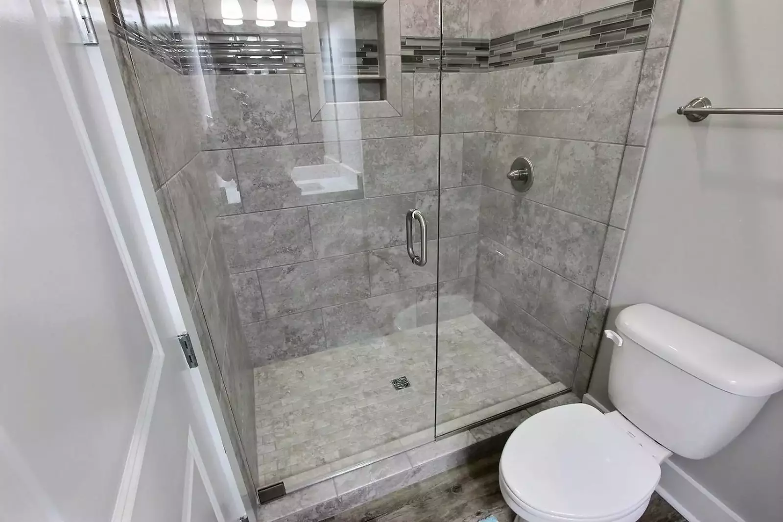 Large tiled walk-in shower in primary bath