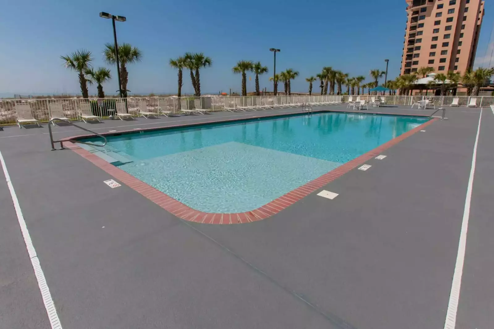 Community pool with lounge chairs